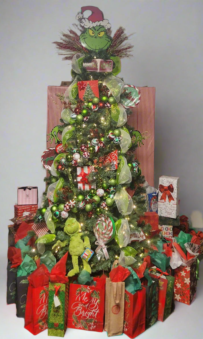 Decorated Christmas tree with Grinch-themed decorations in a room.
