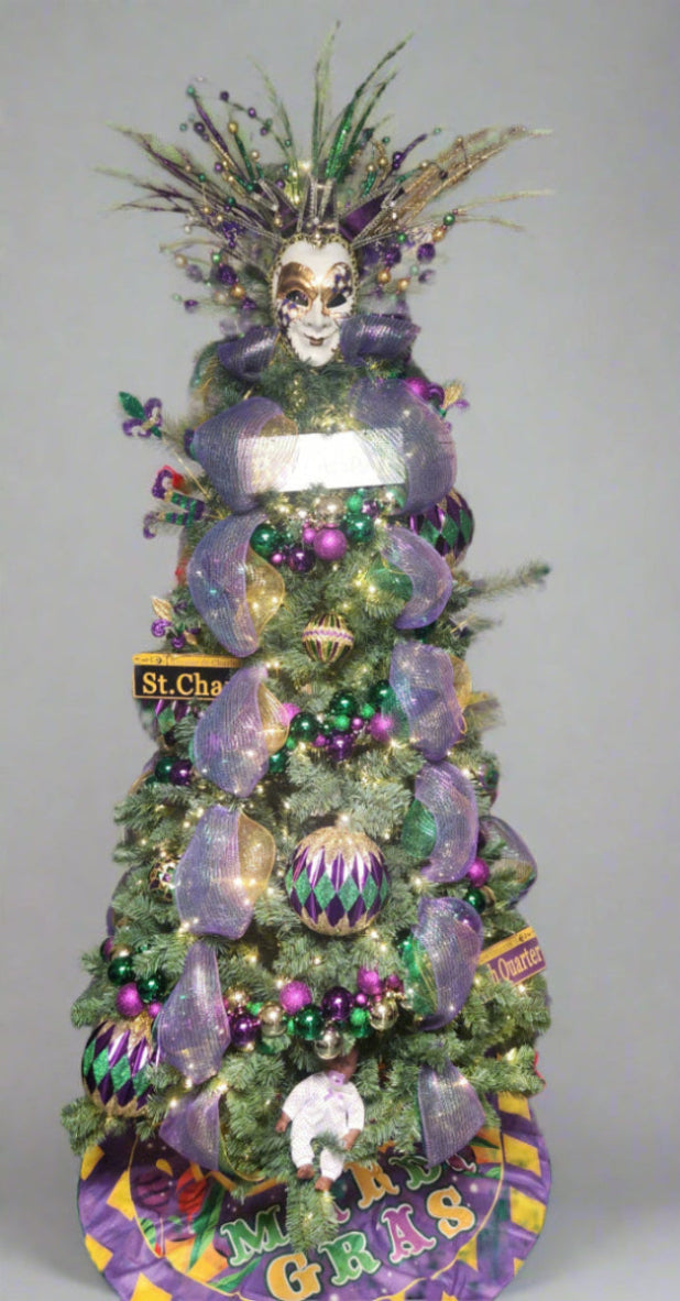 Decorated Christmas tree with Mardi Gras theme, including purple, green, and gold decorations.